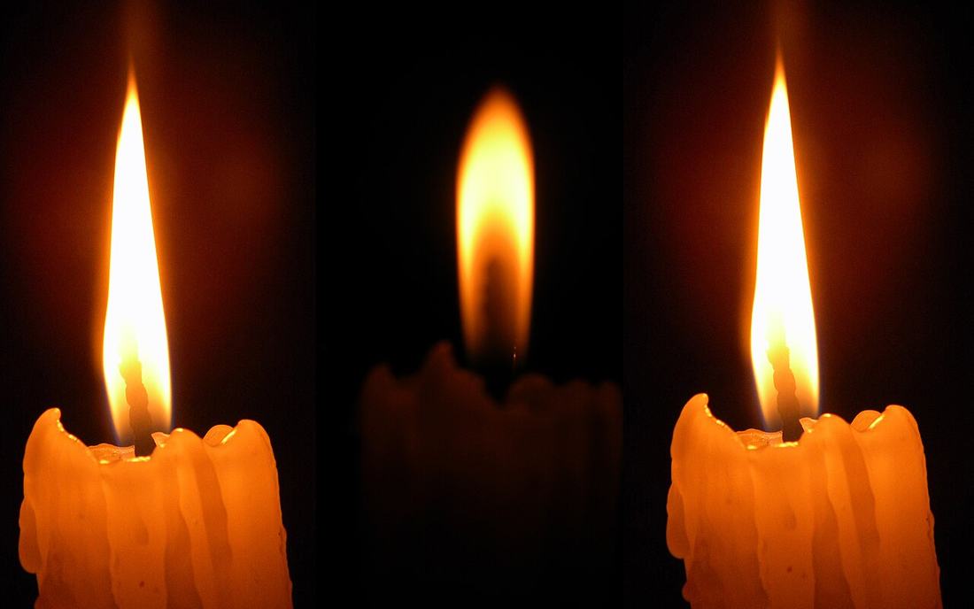 A candle flame in the dark